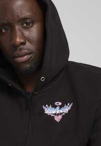 Puma IRIDESCENT HORNETS BASKETBALL - Sweatjacke - black