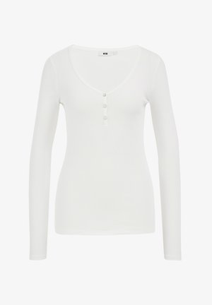 Langärmliges weißes Rippoberteil mit tiefem V-Ausschnitt und drei Knöpfen, aus weichem, dehnbarem Stoff gefertigt.