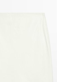 White, smooth skirt with a slight sheen, featuring a simple design and clean edges. Fabric appears lightweight and has minimal texture.