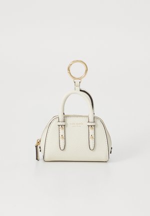 Cream leather mini handbag keychain with gold hardware and zipper, embossed with brand name on front.