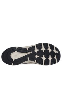 Semelle de chaussure avec une surface en caoutchouc noir texturé et une межsemelle blanche. Comprend des rainures et des motifs pour l'adhérence et la stabilité.