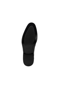 Schwarze Schuhsohle mit runder Form, die ein strukturiertes Griffmuster und glatte Kanten aufweist. Das Material wirkt langlebig und hat ein sauberes Finish.