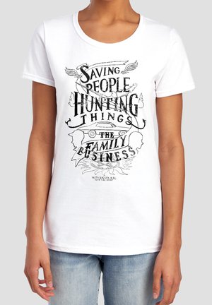Person wearing white t-shirt with black text and graphics reading "Saving People Hunting Things The Family Business" and a car illustration.