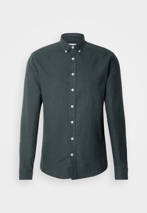 Dark gray button-up shirt with long sleeves, a pointed collar, and white buttons along the front. Features a smooth, textured fabric.
