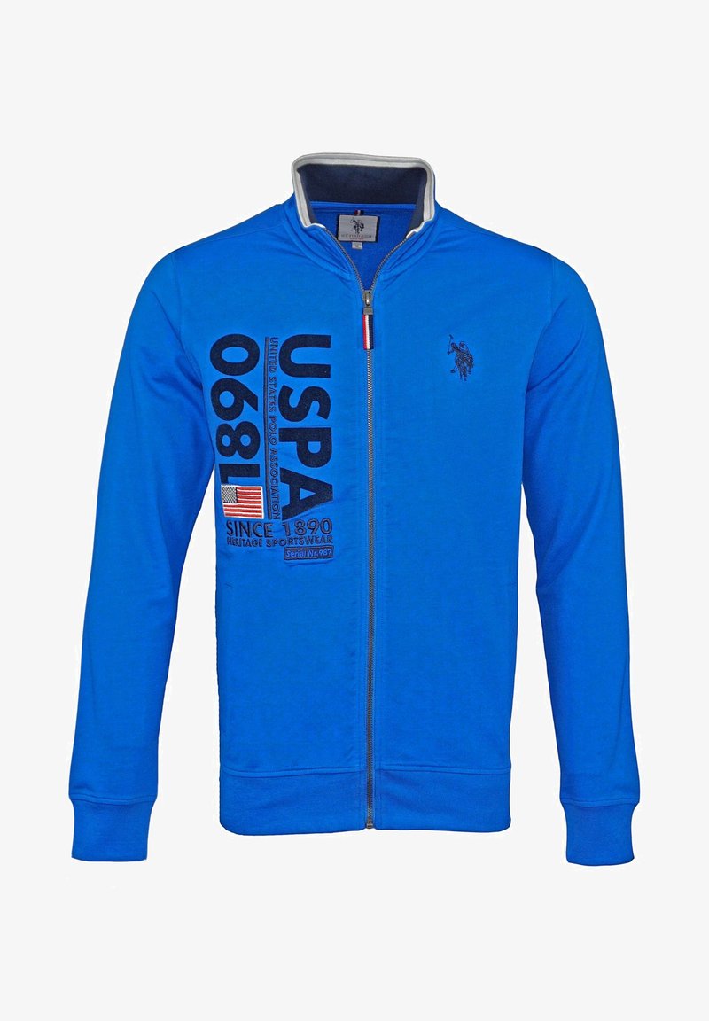 Sweat-shirt bleu zippé avec texte USPA 1890, écusson du drapeau américain et petit logo joueur de polo sur la poitrine, col montant.