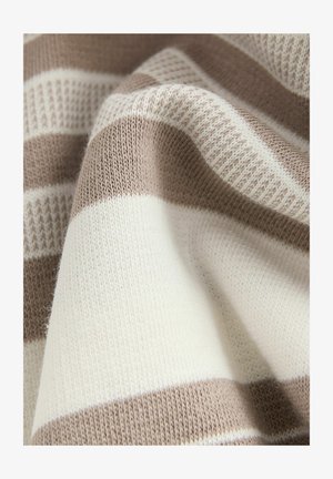 Nertis audinys, kuriame kaitaliojasi grietinėlės ir šviesiai rudos juostos. Turi smulkią tekstūrą su švelniu, glotniu paviršiumi.