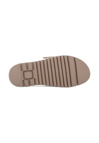 Brown rubber shoe sole with horizontal ridges, textured for grip. Features logo and rounded shape, designed for comfort and traction.