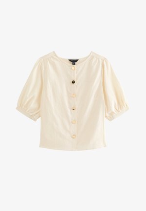 Blusa crema de manga corta con escote redondo, mangas abullonadas y cinco botones decorativos variados en la parte delantera.