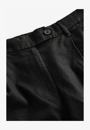 Čierne ľanové nohavice s uzáverom na gombík a elastickým pásom. Tkanina pôsobí zdrsneným dojmom s viditeľnými švami.