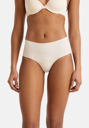 Beige seamless high-waisted underwear made of smooth elastic fabric, featuring a minimalistic design with no visible seams or patterns.