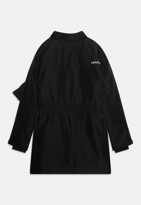 Černá bunda Levi's s dlouhým rukávem, elastickým pasem, malým bílým logem na horní části zad a nastavitelnými manžetami, zobrazená zezadu.