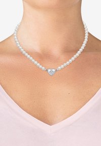 Collana di perle con un centrale a forma di cuore in argento. Le perle sono bianche, di dimensioni medie, con una superficie liscia. Il cuore presenta dettagli decorativi.