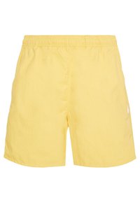 Yellow swim shorts with an elastic waistband, made of lightweight material. Features a simple design and a small white logo on one side.