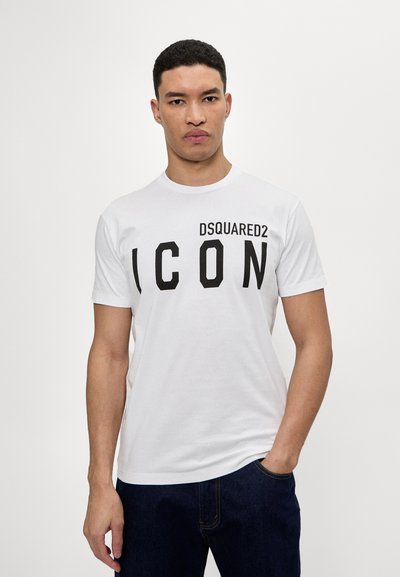 Maglietta bianca a maniche corte con scollo rotondo. Logo nero "DSQUARED2 ICON" sul petto. Realizzata in cotone, di texture liscia.