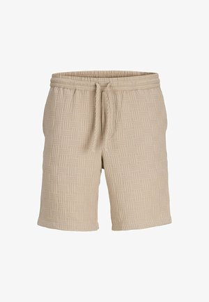 Béžové vzorované šortky s elastickým pásom a šnúrkou. Textúrovaná tkanina má po celom povrchu tkaný dizajn.