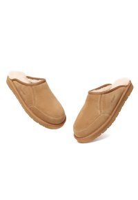 Tan suede slippers with faux fur lining, open back, smooth exterior, and rubber sole, featuring subtle stitching and logo detail.
