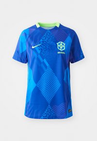 Blue athletic jersey made of synthetic fabric, featuring a geometric and animal print pattern, with green accents and a logo detail.