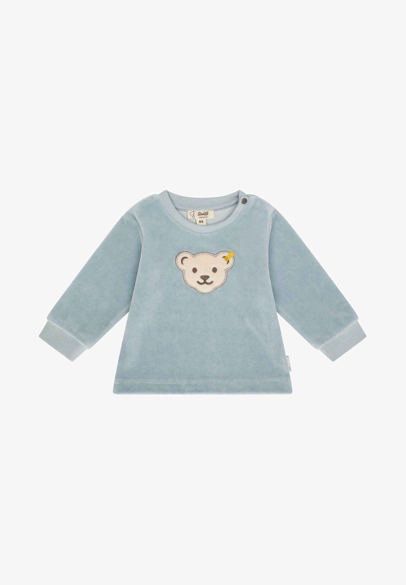 Maglione di pile azzurro chiaro con maniche lunghe e scollatura tonda. Presenta un ricamo a forma di faccia di orso sulla parte anteriore e bottoni a pressione sulla spalla.