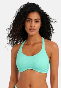 Bikini top v mátově zelené barvě s texturovaným, žebrovaným designem a zavazováním za krkem, s kulatým výstřihem a mírným nařasení na spodní části.