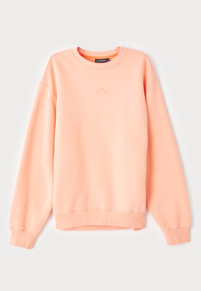 Persiko spalvos džemperis su ribotu rankogaliu ir apačia, turintis apvalų kaklą ir subtilų logotipą siuvinėtą ant krūtinės. Švelni medvilnės mišinys.