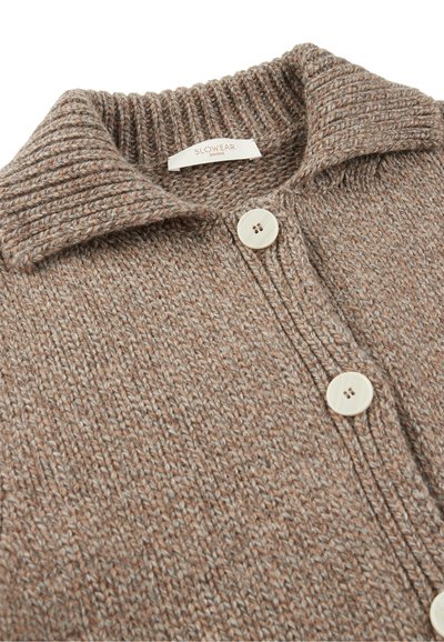 Brązowy sweter robiony na drutach z prążkowanym kołnierzem, z dwoma jasnymi guzikami i teksturowanym wzorem na całej tkaninie.