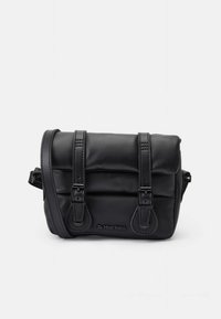 Black leather crossbody bag with two buckled straps, padded design, visible stitching, and a logo on the front. Compact and rectangular shape.