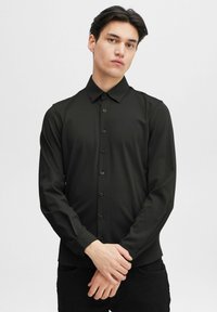 Black long-sleeve button-up shirt with a collar, made from smooth fabric, featuring front buttons and fitted sleeves.