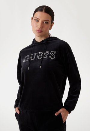 Zwarte hoodie van zachte stof met het woord "GUESS" in strassstenen. Inclusief een voorzak en een verstelbare trekkoordkap.