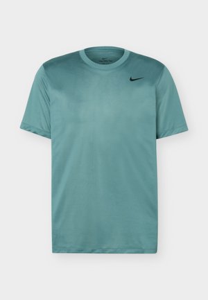 T-shirt de sport Nike Dri-FIT à manches courtes de couleur sarcelle avec col rond et petit logo Nike swoosh noir sur la poitrine.