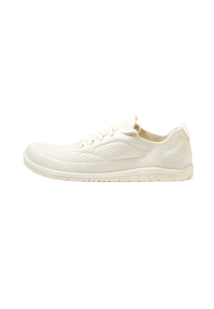 Lightweight, cream-colored sneaker with a breathable mesh upper, textured surface, lace-up design, and a flexible rubber sole.