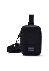 Black fabric crossbody bag with adjustable strap, rectangular shape, textured surface, and prominent brand label on the front.