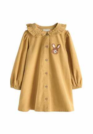 Mosterdgele corduroy jurk met een gerimpelde kraag, lange pofmouwen en een geborduurd konijntje op de borst. Sluiting met knopen aan de voorkant.