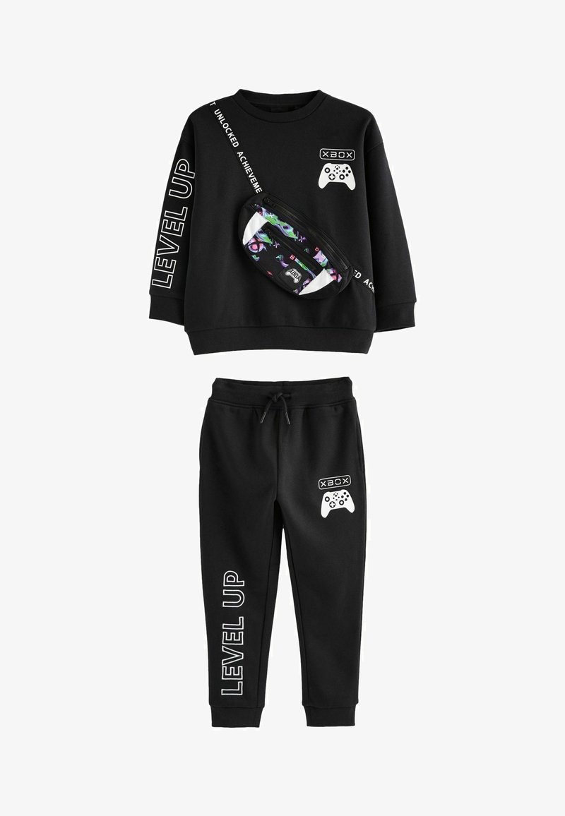 Black sweat suit featuring a long-sleeve top with white text and graphic designs, and matching pants with a drawstring waist. Includes a patterned fanny pack.