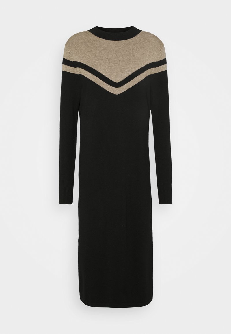 Robe en tricot avec un corps noir et un motif chevron noir et beige au niveau du col. Manches longues et coupe droite.