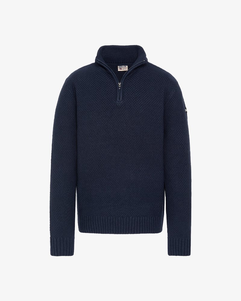 Granatowy sweter z kołnierzem na suwak do ćwiartki, teksturowaną dzianiną oraz ściągaczami na mankietach i dole. Posiada metkę marki na kołnierzu.