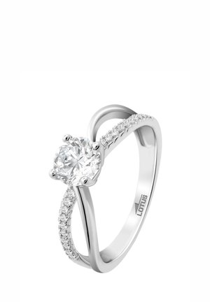 Silver ring featuring a central round diamond with a smooth band and small accent stones along one side, showcasing a sleek design.