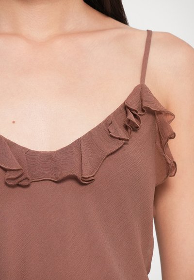 Brown sleeveless blouse featuring a ruffled neckline detail, made from lightweight fabric with a smooth texture.