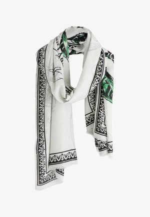 White scarf with black decorative border and green leaf pattern, loosely draped with fringed edges.