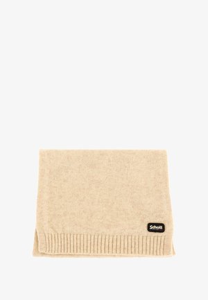 Écharpe en tricot beige pliée avec des bords côtelés et une petite étiquette en tissu noire Schott New York dans un coin.