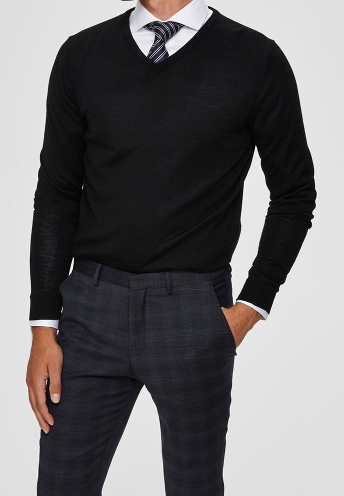 Black v-neck sweater made of fine knit fabric, paired with plaid blue trousers. Sweater features long sleeves and a slim fit design.