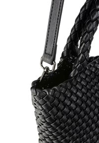 Borsa a tracolla in pelle intrecciata nera con superficie testurizzata, dotata di manici intrecciati e di una tracolla staccabile, fissata da hardware metallico.