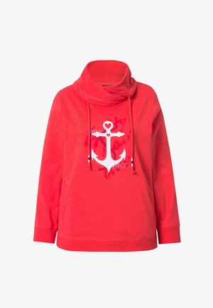 Červená mikina s vysokým složeným límcem, předními kapsami, šňůrkami a bílým kotvou srdíčkovým motivem a nápisem "1987" na hrudi.