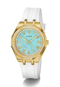 Gold octagonal watch with a turquoise face, Roman numerals, and crystal embellishments, featuring a white silicone strap.