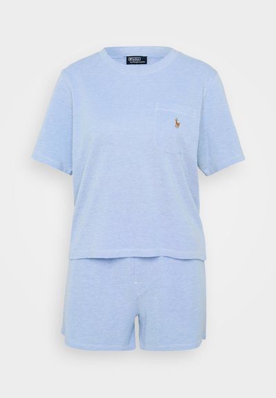 Ανοιχτό μπλε βαμβακερό σετ ύπνου με κοντομάνικο μπλουζάκι που διαθέτει τσέπη και κεντητό λογότυπο, συνοδεύεται από ταιριαστά σορτσάκια. Μαλακή υφή.