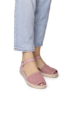 Pink crocheted espadrille sandals with a woven design, open toe, and ankle strap, featuring a natural rope sole and light fabric.