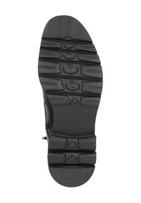 Sole in gomma nera con un pattern di presa testurizzato e segmenti di battistrada multipli. Presenta accenti circolari per la trazione. Design a bordo liscio.