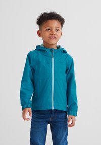 Teal lightweight jacket with a hood, front zipper, elastic cuffs, and chest seam. Paired with blue jeans. Texture appears smooth and durable.