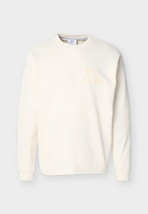 Off-white long-sleeve sweatshirt with ribbed cuffs, textured elbow panels, crew neck, and "EST 1978" printed on the upper left chest.