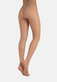 Collant trasparenti beige con una texture liscia, design aderente e punta senza cuciture. La vita è elastica, garantendo una vestibilità aderente.