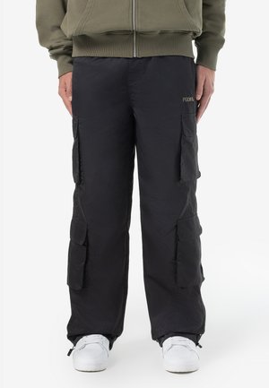 Black cargo pants made of lightweight material, featuring multiple side pockets and a relaxed fit design. Subtle branding near the waistband.